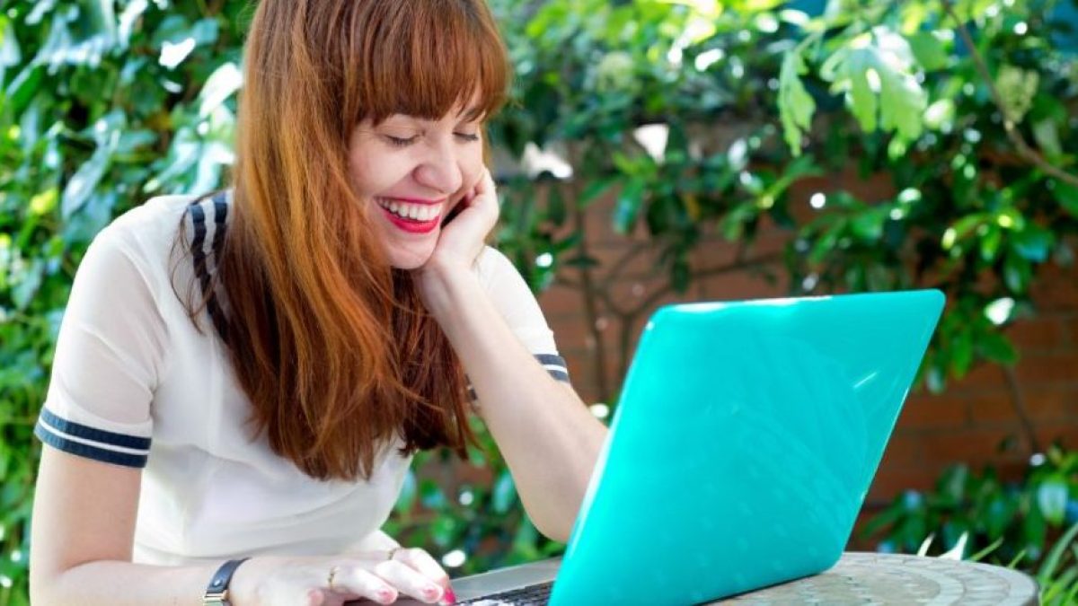 Teacher happily using the best AI essay graders for teachers